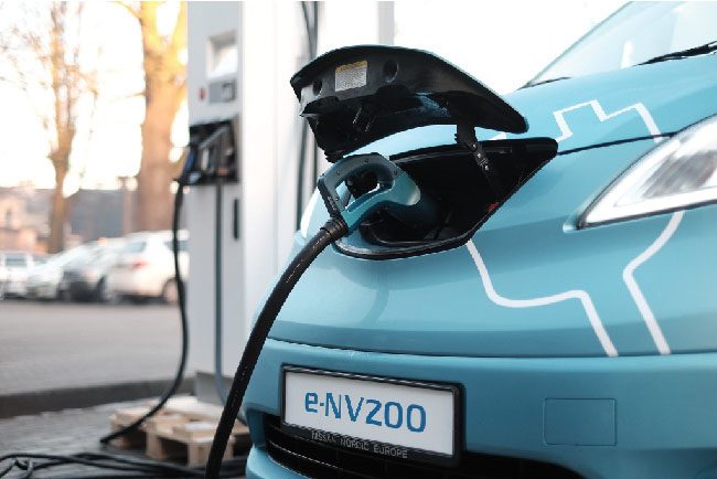 An electric car gets recharged. (credit: “Nissan e-NV200 electric car” by Kārlis Dambrāns, flickr).
