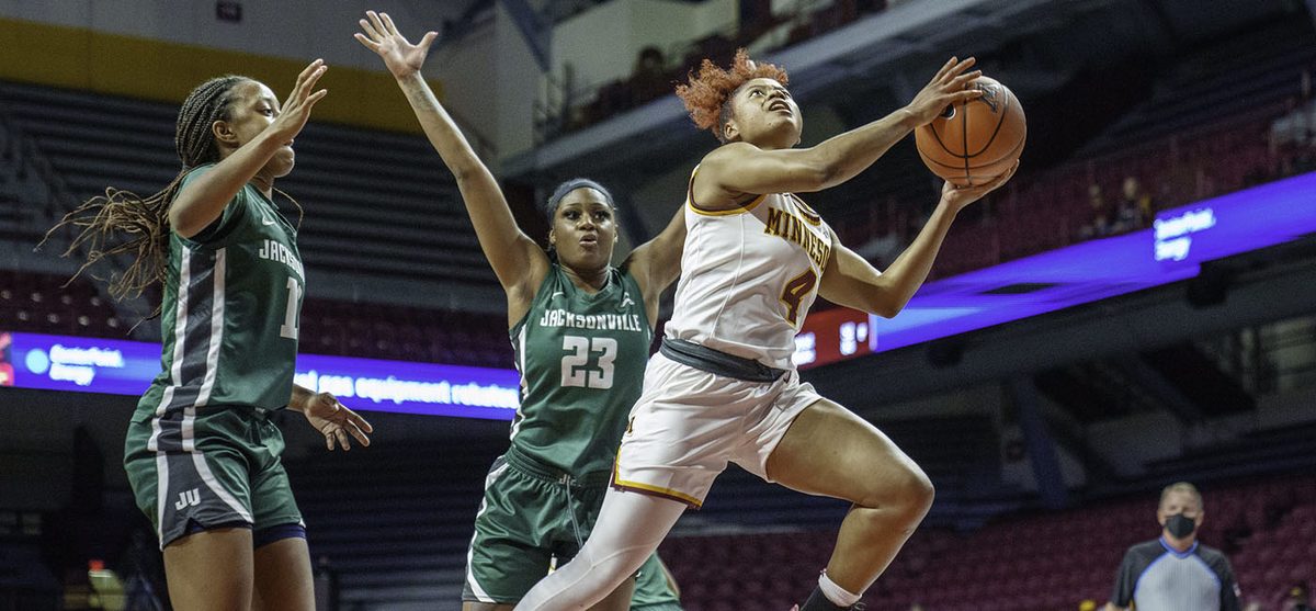Three women playing basketball.