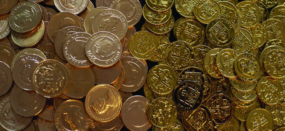 A shimmering bounty of gold coins, divided into two distinct piles, one with intricate Austrian designs and the other with classic treasure chest motifs.