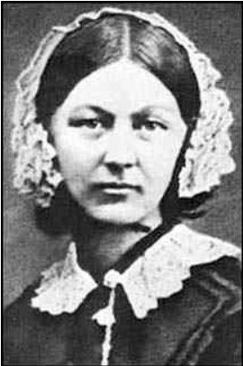 Black-and-white portrait photograph of Florence Nightingale, a young woman wearing a lace cap and lace collar over a dark dress.