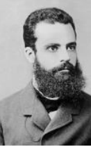 Black-and-white portrait photograph of Vilfredo Pareto, a man with a full dark beard wearing a formal suit.