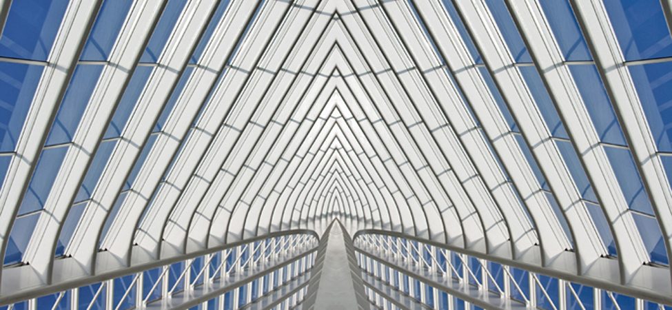 Part of a glass building is shown. The structure is made up of individual shapes.