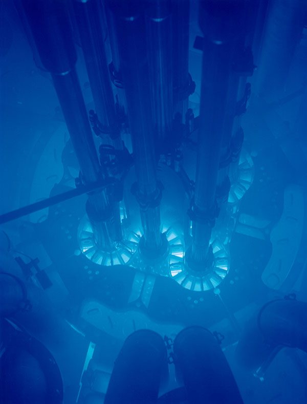 Picture is a photograph of the blue glow in a reactor pool.
